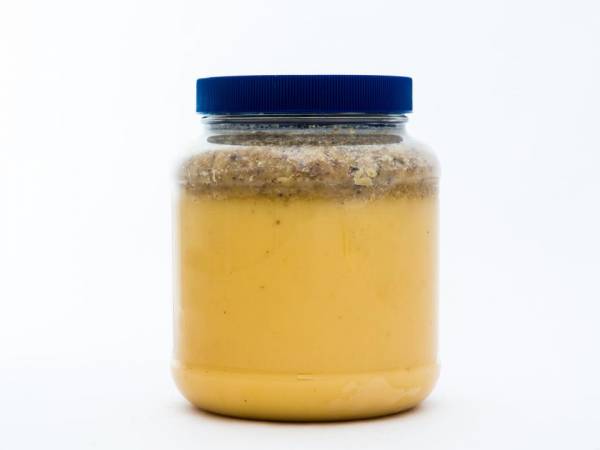 5 lb. Plastic Jar of Really Raw Honey with an extra amount of our cappings on top